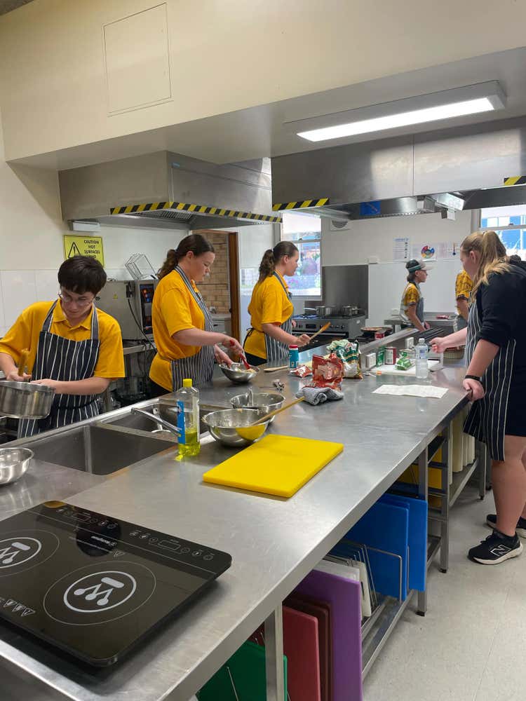 students preparing food in food technology classroom